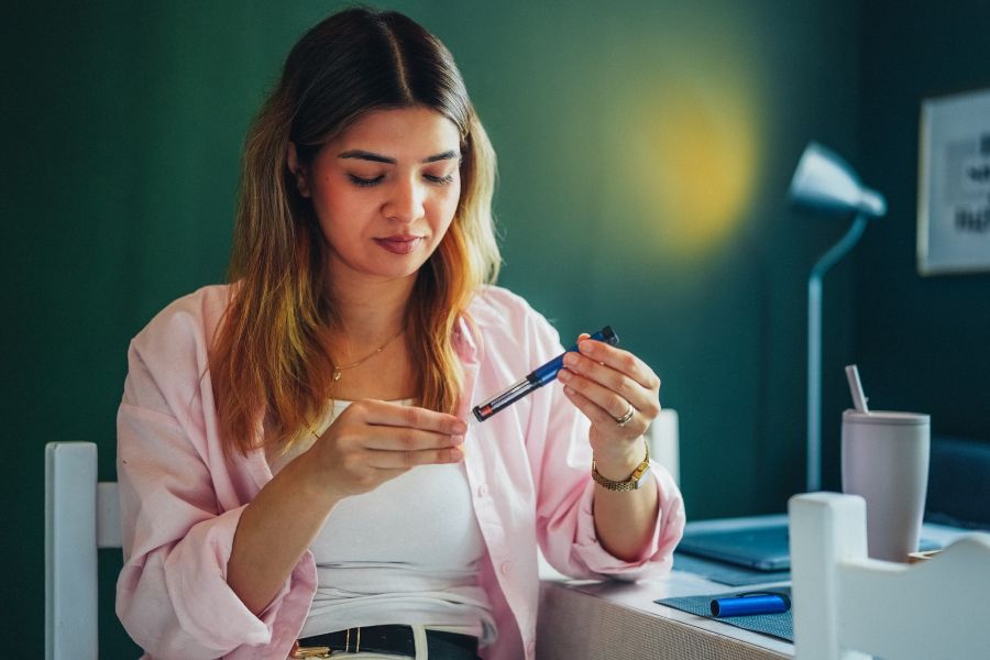 Getty image of  Young Woman Using GLP-1 Injection at Home